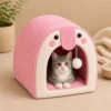 Grey tabby kitten sitting inside pink Cat Cave Bed