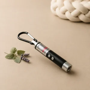 Cat laser pointer toy with carabiner clip beside lavender sprigs