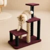 Kitten stepping down between platforms on Multi-Level Cat Tree Tower